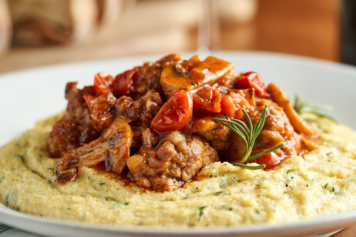Salsiccia — homemade sausage, tomatoes, and mushrooms over creamy polenta.